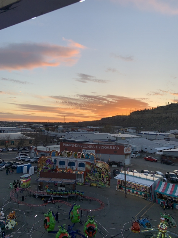 a picture of the sunset on the ferris wheel at the carnival