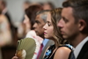 Woman keeping cool at wedding in centuries-old cathedral (beautiful but stuffy)